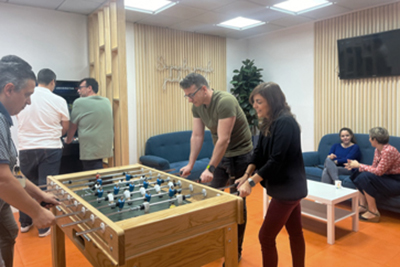 Staff playing table football in the UNIVERSITAS XXI dining room